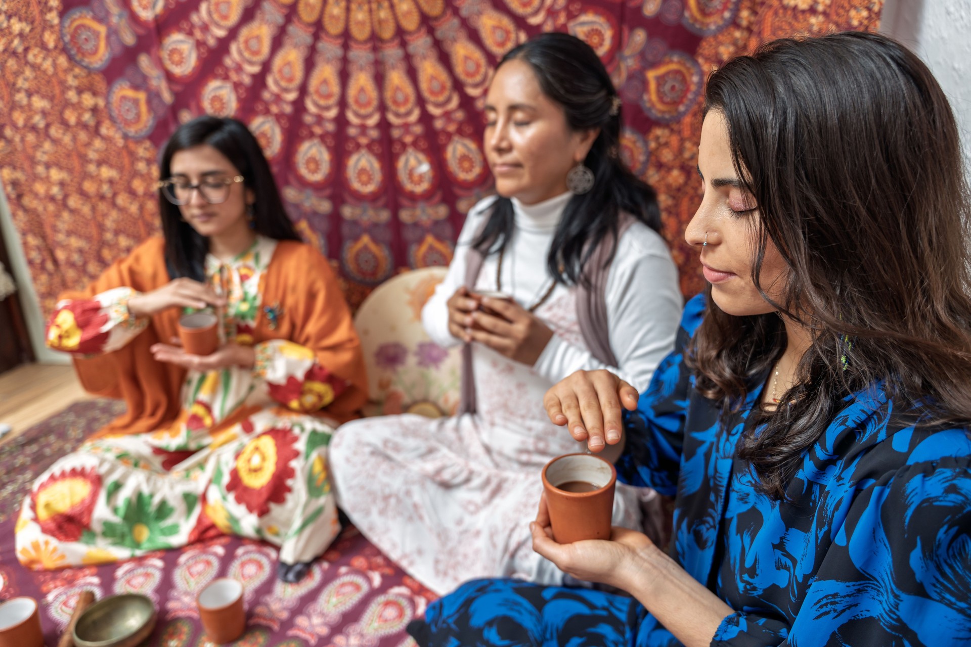 Women enjoying a cacao ceremony for wellbeing and alternative medicine